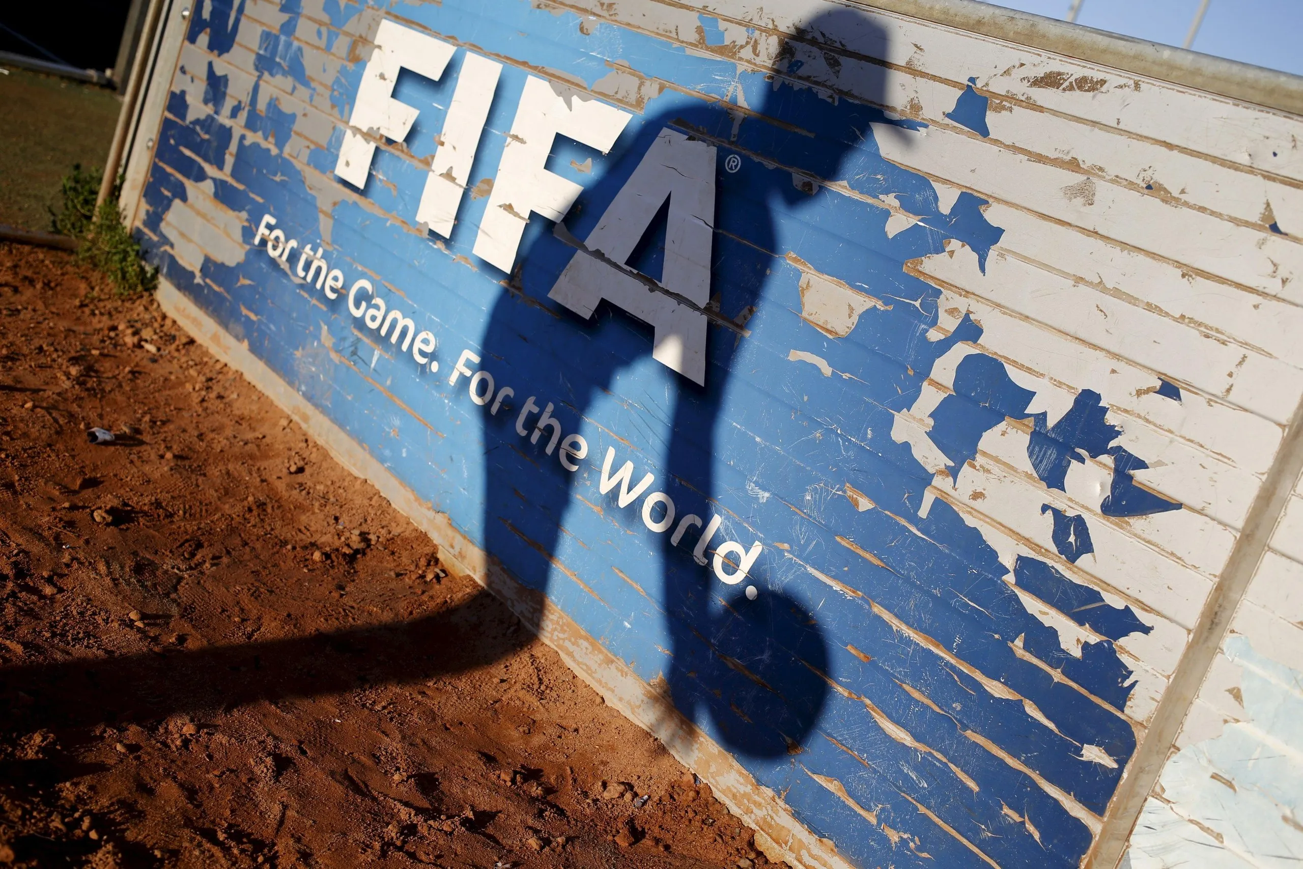 A child collects a ball beside an artificial pitch at the Football Centre for Hope in Cape Town’s Khayelitsha township, one of several built by Fifa in South Africa in the run-up to the 2010 World Cup