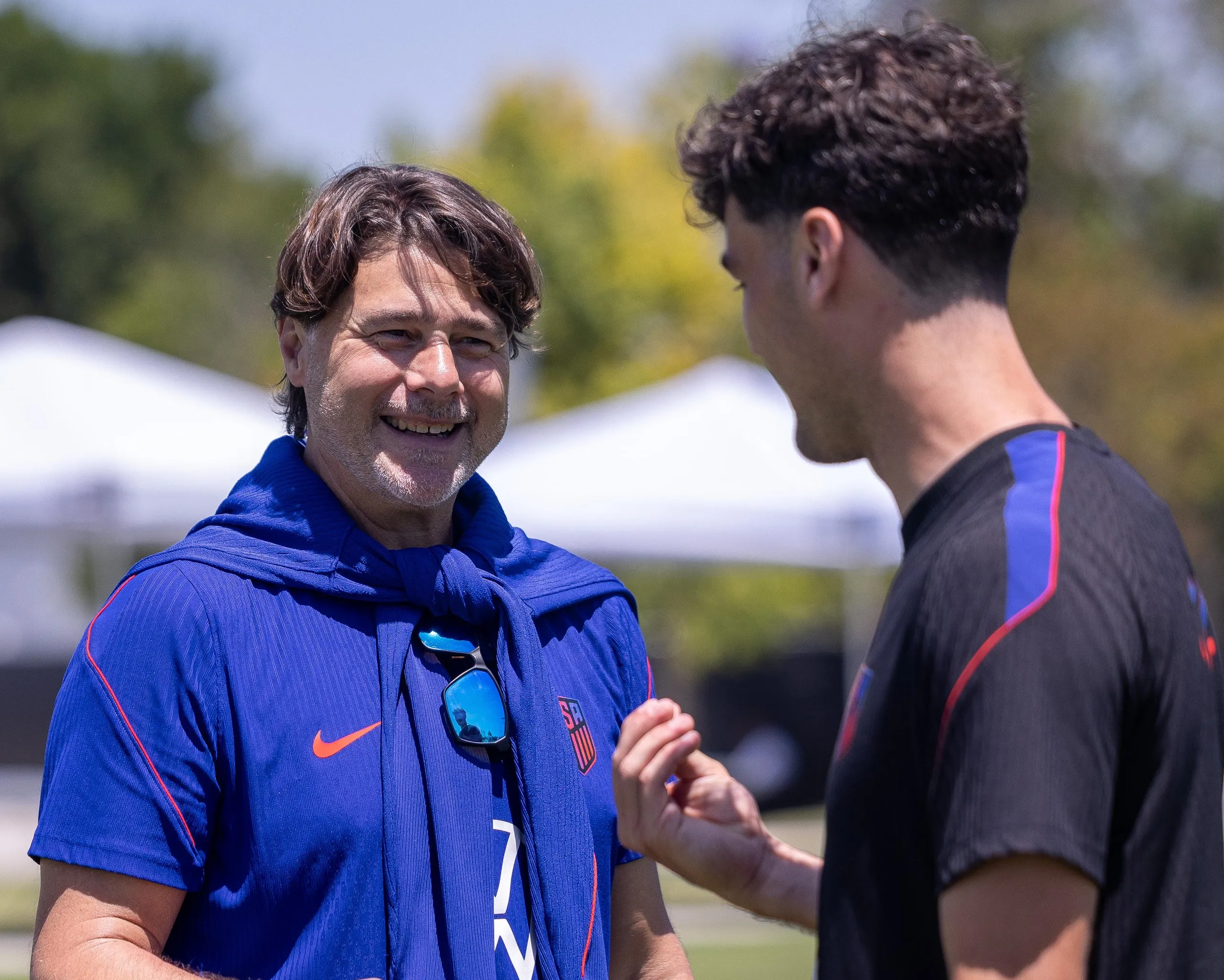 Gio Reyna chats to head coach Mauricio Pochettino during a training session.